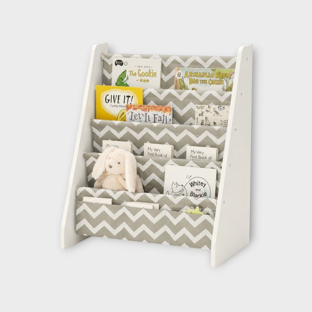 modplay Montessori wooden bookshelf with grey chevron fabric pockets holding children's books and a plush toy