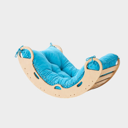 modplay Montessori wooden rocker with a bright blue cushioned seat for active play and relaxation